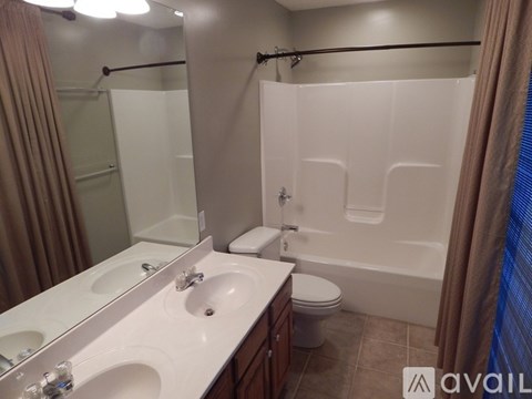 A bathroom with a white sink and a white toilet.