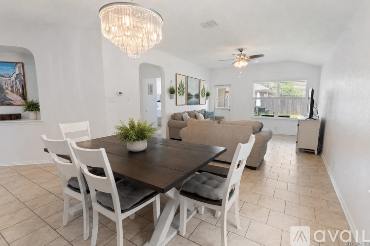 A dining room with a table set for four.
