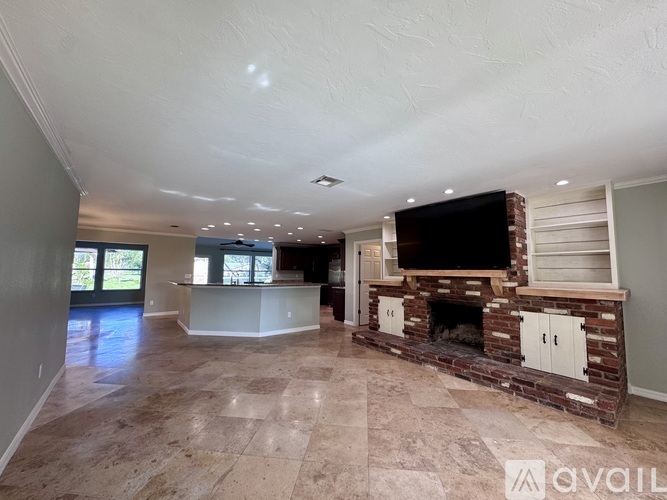 A spacious living room with a fireplace and a television.