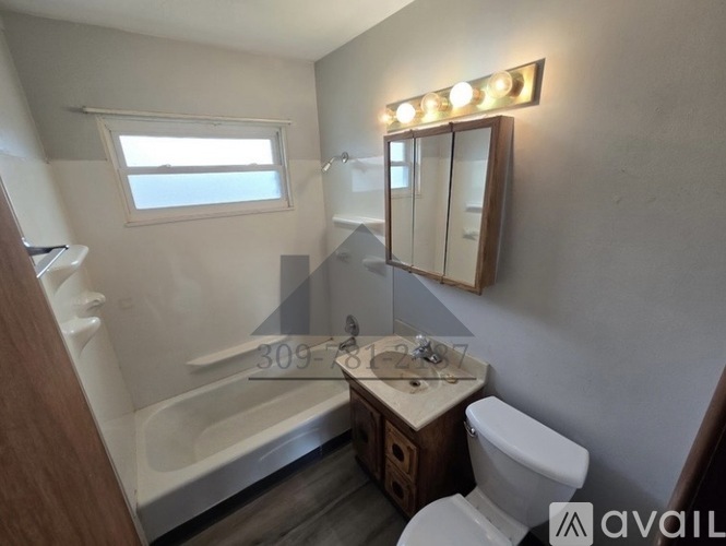 A bathroom with a toilet, sink, and bathtub.