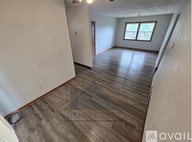 A room with wooden flooring and a window is available for rent.