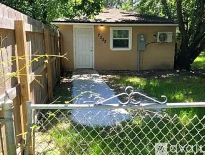 A small backyard with a fence and a shed.