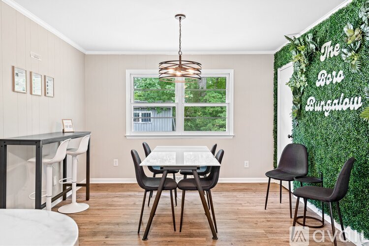 A dining room with a white table and chairs.