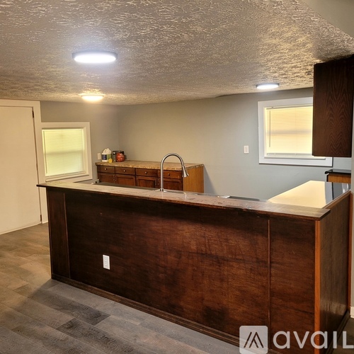 A kitchen with a wooden island and a sink.