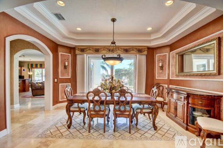A dining room with a table set for six.