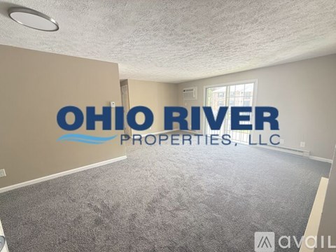 A room with carpet flooring and a logo that reads "Ohio River Properties, LLC.".