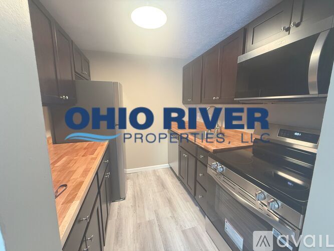 A kitchen with a wooden countertop and stainless steel appliances is on the market with Ohio River Properties, LLC.