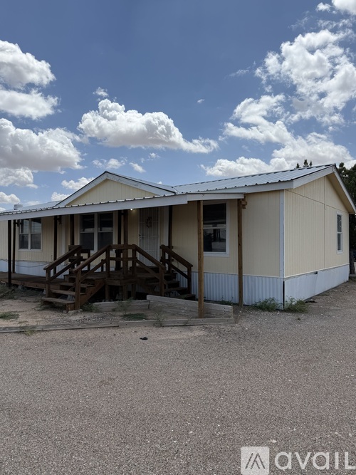 A small building with a porch and a roof.