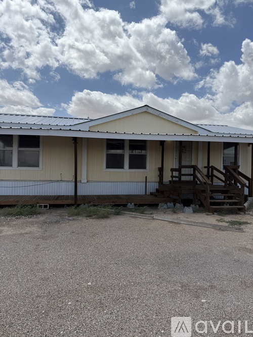 A house with a gravel driveway in front.
