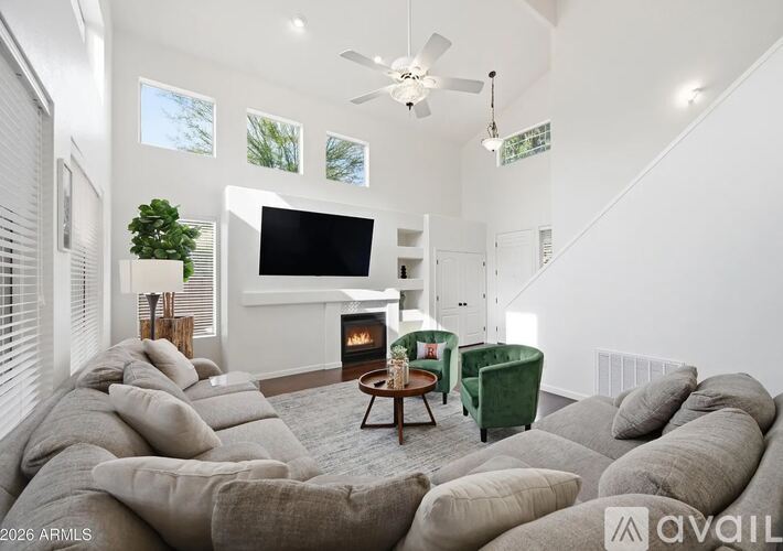 A living room with a grey sofa and a green armchair.