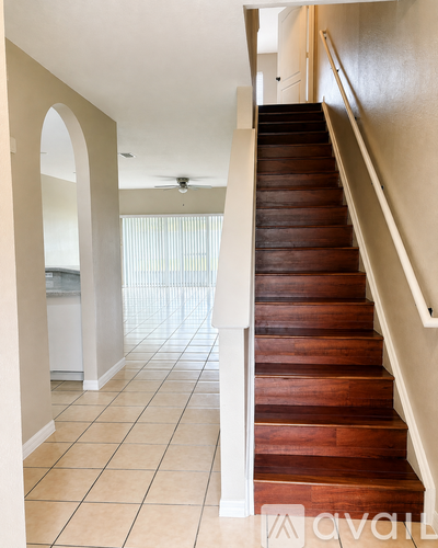 A staircase with a wooden tread and white risers.