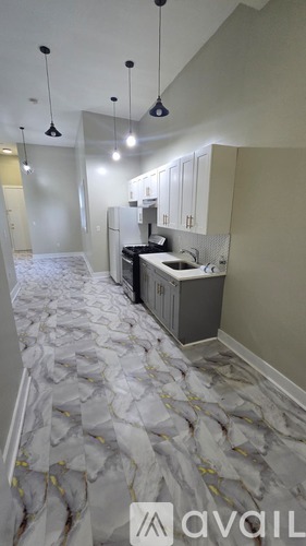 A kitchen with a marble floor and a cabinet.