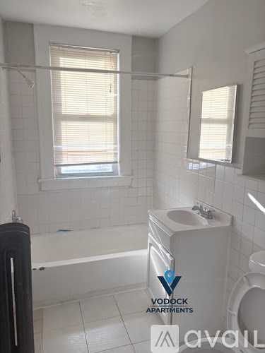 A bathroom with a bathtub, toilet, and sink.