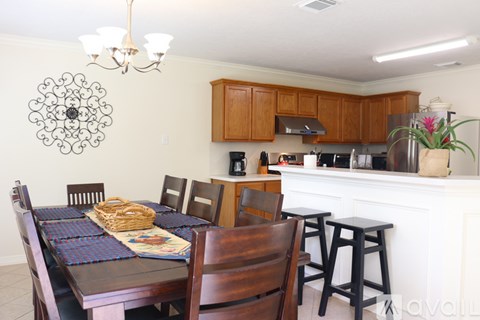 A kitchen with a table set for a meal.