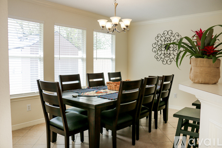 A dining room with a table set for six.