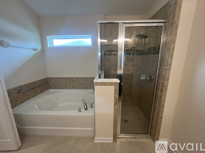 A bathroom with a tub, sink, and shower.