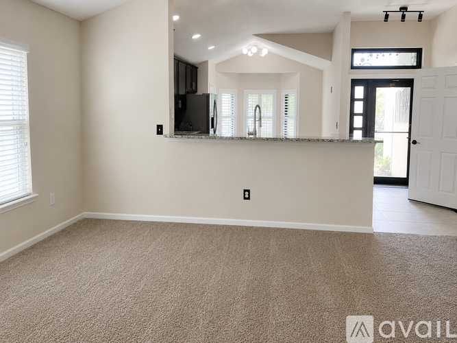 A spacious living room with a large mirror and a flat screen TV mounted on the wall.