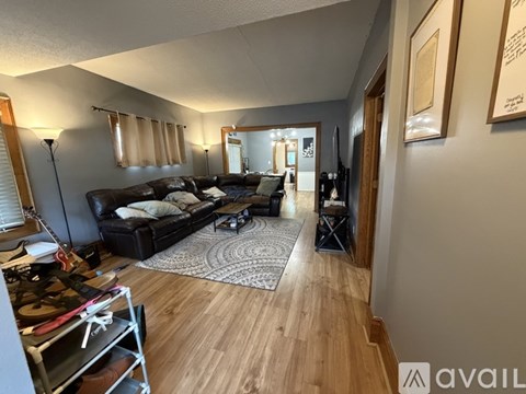 A bedroom with a bed, a fan, and a mirror.