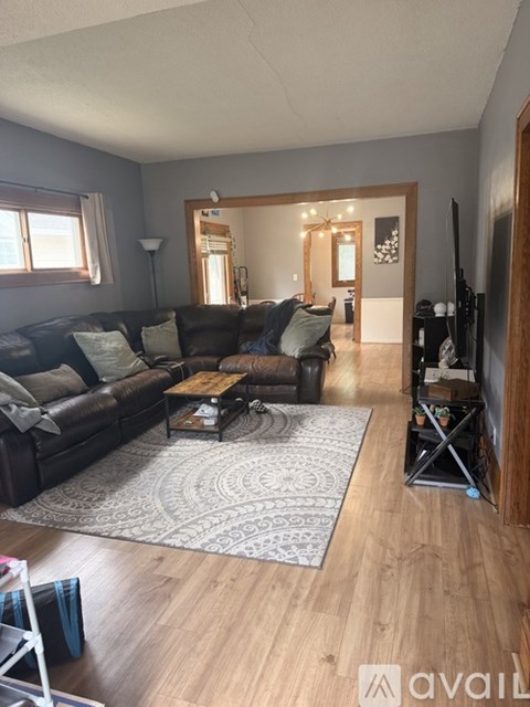 A living room with a black couch and a coffee table.