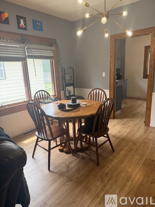 A dining room with a wooden table and chairs.