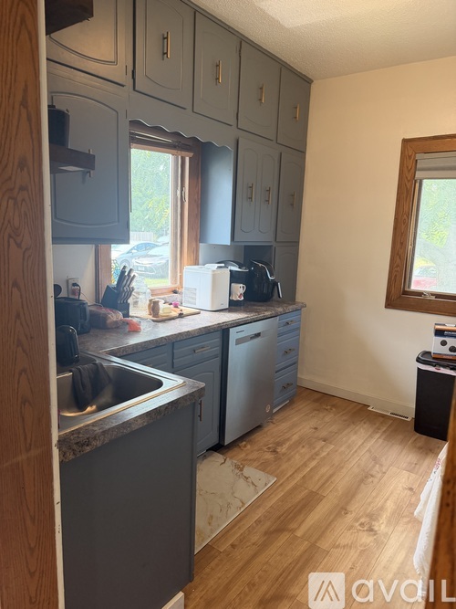 A kitchen with wooden cabinets and a window.