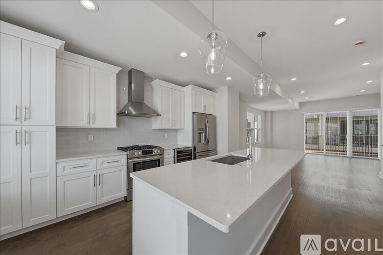 A modern kitchen with white cabinets and a large island.