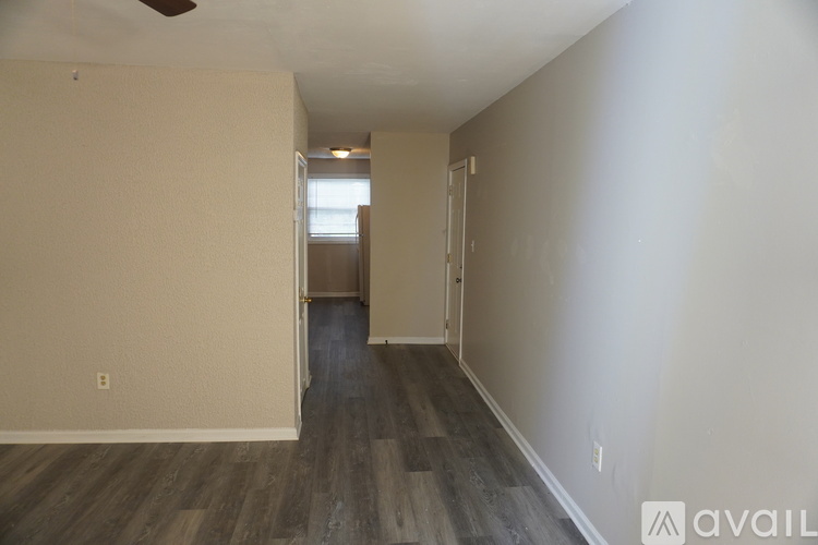 A room with wooden flooring and a ceiling fan.