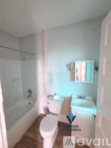 A bathroom with a toilet, sink, and bathtub.