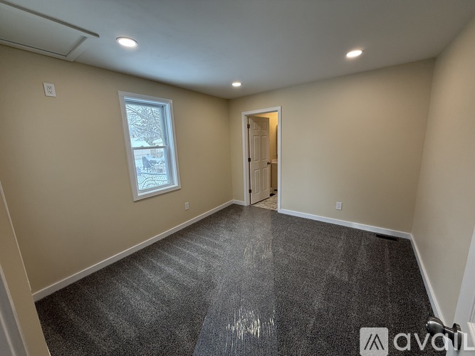 A room with a grey floor and a window.