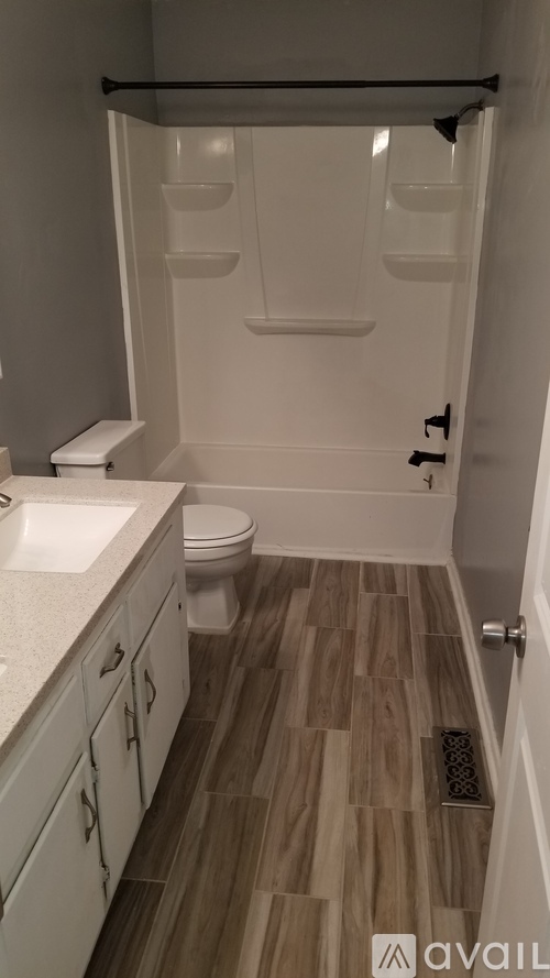 A bathroom with a toilet, sink, and bathtub.