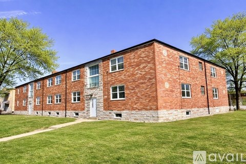 A red brick building with a white door and windows.