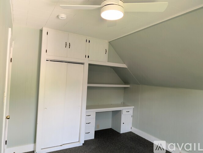 A room with a desk, drawers, and a cabinet.