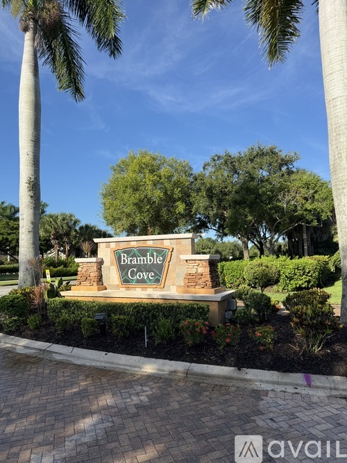 A sign that says Bramble Cove is surrounded by greenery.