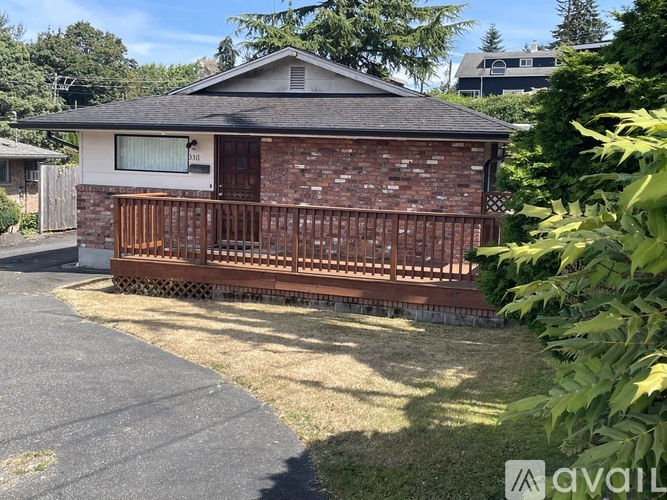 A house with a brick facade and a wooden fence.