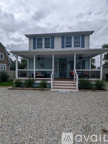 A house with a porch and a front yard.