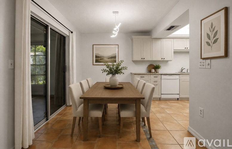 A dining room with a table set for four.