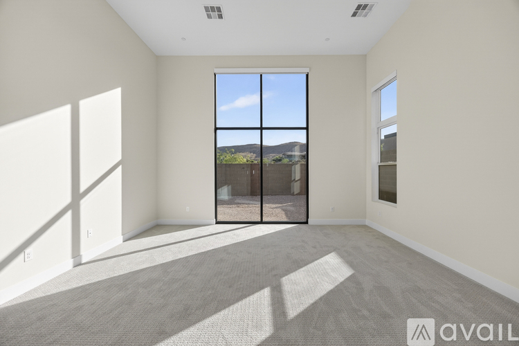A spacious room with a large window and a view of the outdoors.