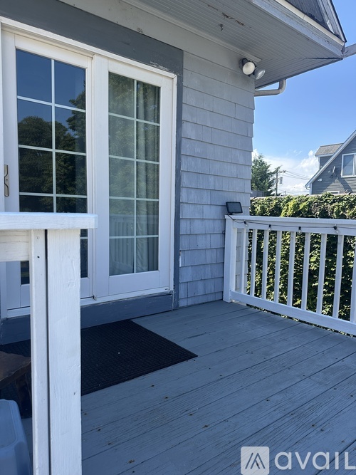 A deck with a railing and a window.