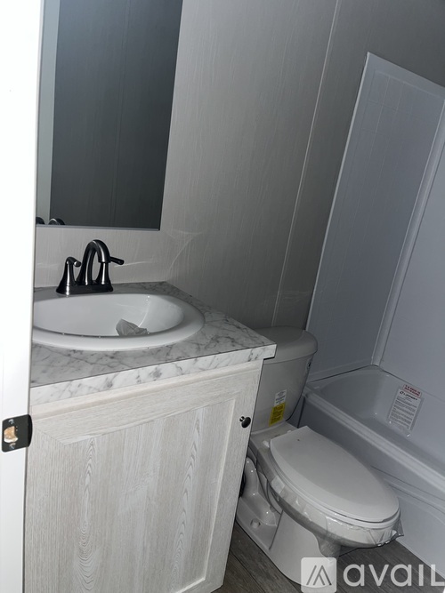 A bathroom with a sink, toilet and tub.