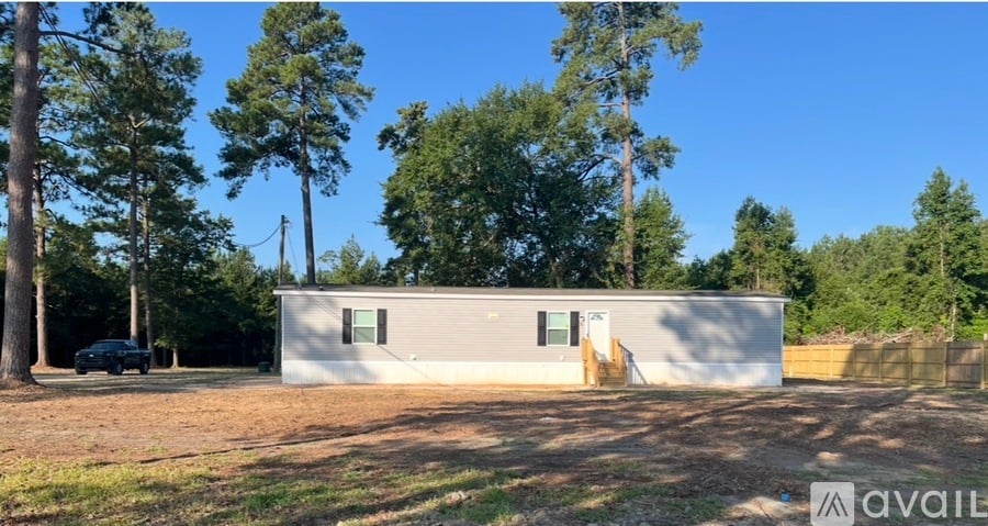 A house with a car parked in front is for sale.