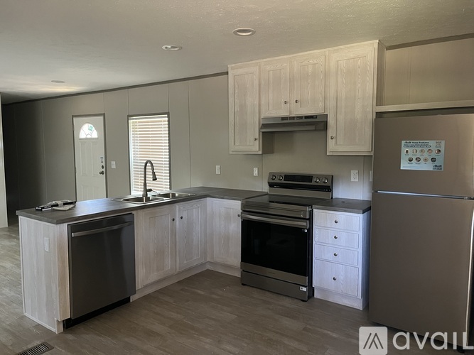 A kitchen with wooden cabinets and stainless steel appliances.