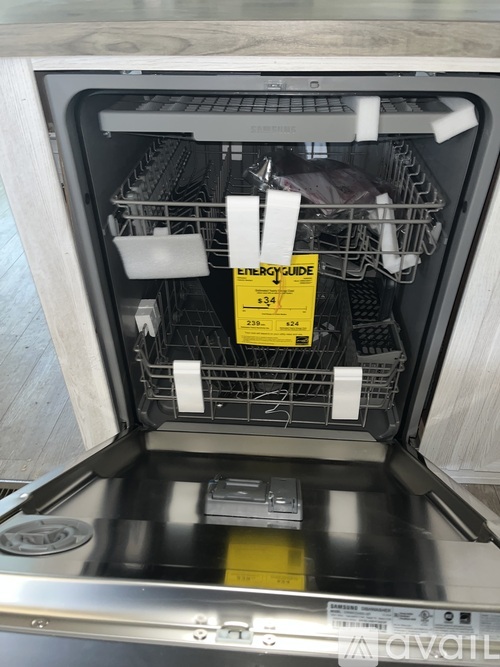 A dishwasher with a yellow label that says "EnergyGuide" on it.