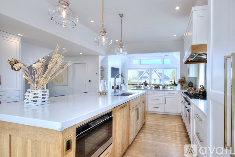 A modern kitchen with wooden cabinets and white countertops.