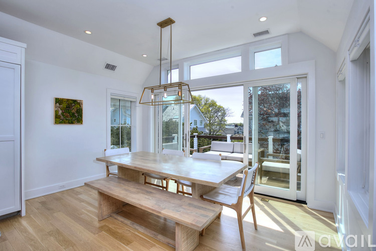 A modern dining room with a wooden table and bench.