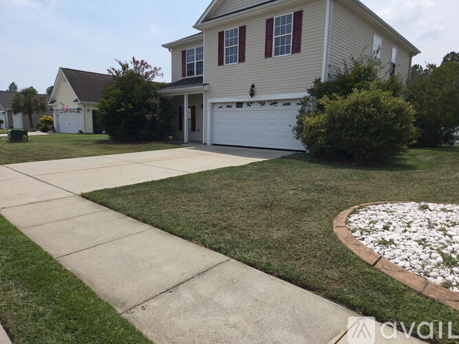 A house with a white garage door and a driveway.