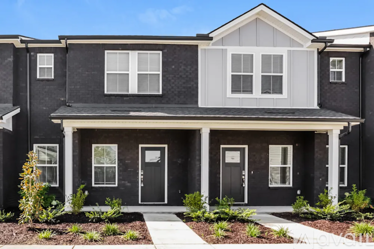 A modern two-story house with a black and white exterior.