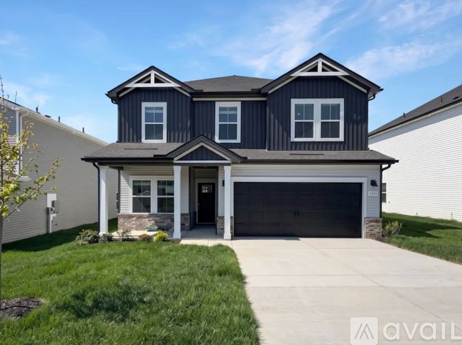 A two-story house with a garage is available for sale.