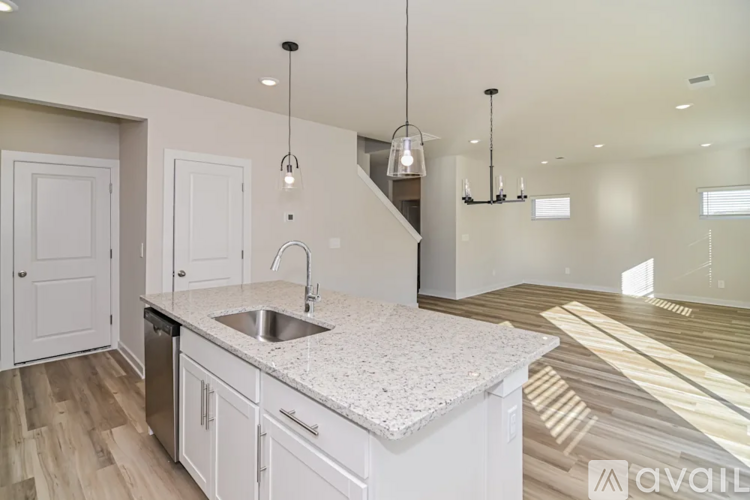 A kitchen with a granite countertop and a sink.