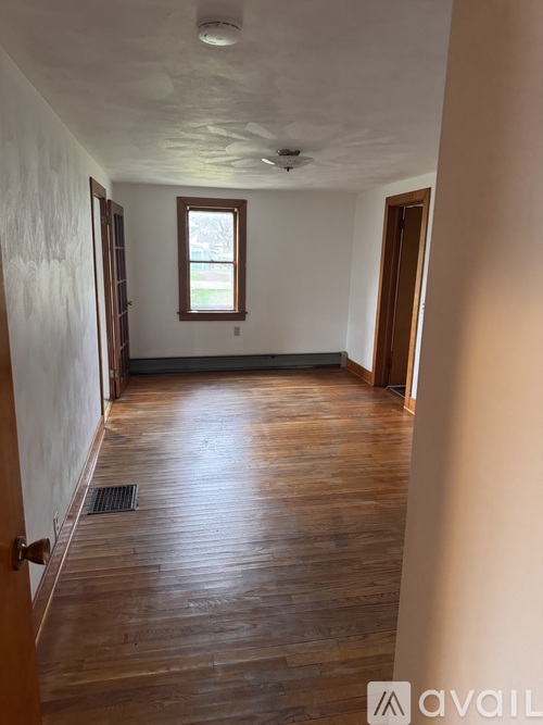 A room with wooden floors and a window.