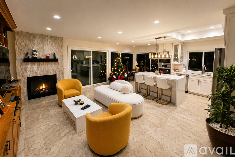 A living room with a fireplace and a Christmas tree.